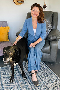 Meredith seated with her pet dog